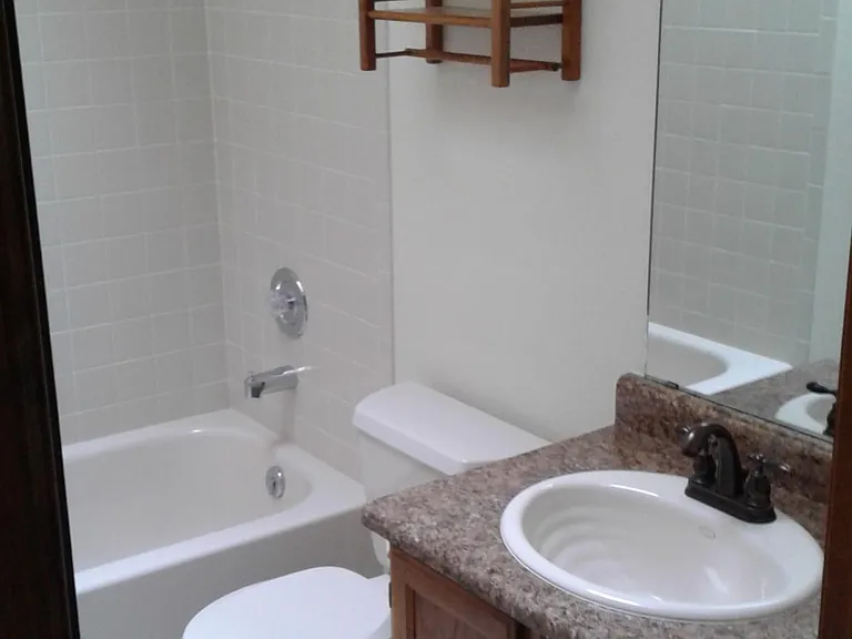 Upstairs bath with bathtub shower combination.