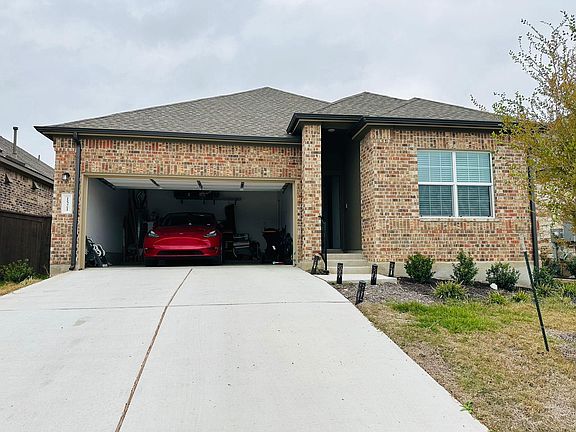 Two car garage with electric outlet and overhead storage space