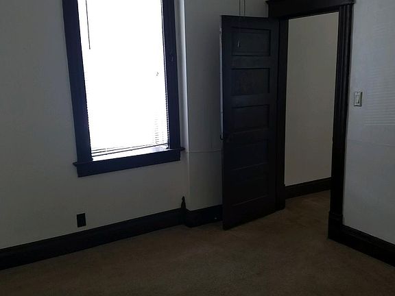 DOOR FROOM BEDROOM TO THE LIVING ROOM. ALL WINDOWS HAVE MINI BLINDS