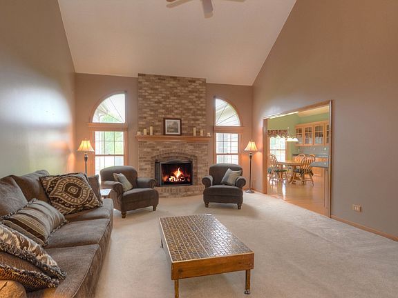 Vaulted and Ceiling fan open to Kitchen