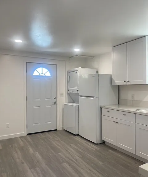 entry door to kitchen with refrigerator/freezer and washer/dryer