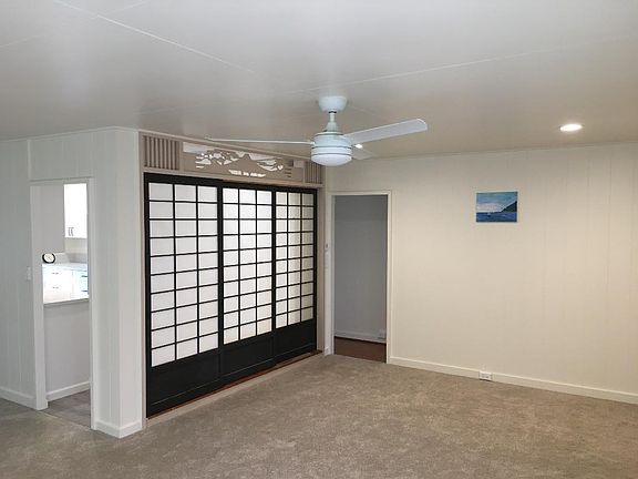 Living room toward hallway, kitchen, and closed shoji doors.