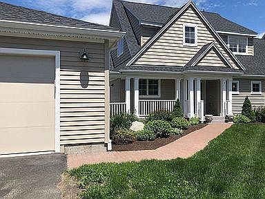 Front of house. Integrated double garage at left (walk through covered passage). Gardens beautifully maintained by Association.