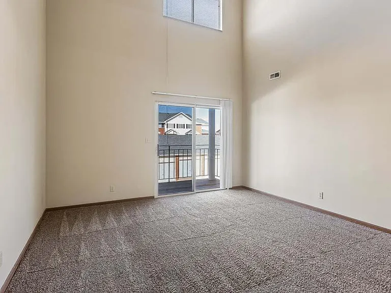 The soaring ceilings and dramatic wall of windows fill this expansive living area with natural light, creating a bright and inviting place to gather and unwind.
