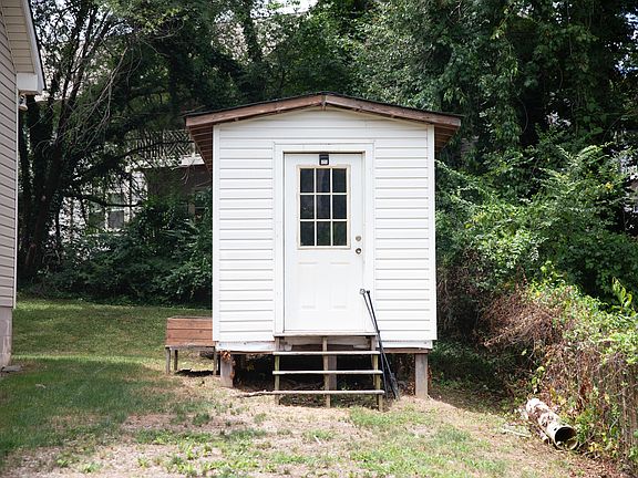 Spacious shed with room for bike and kayak storage as well as a work bench for project space.