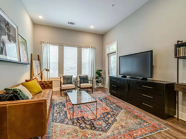 Open Living Area with Leather Sofa, Bold Art, and Oversized Windows