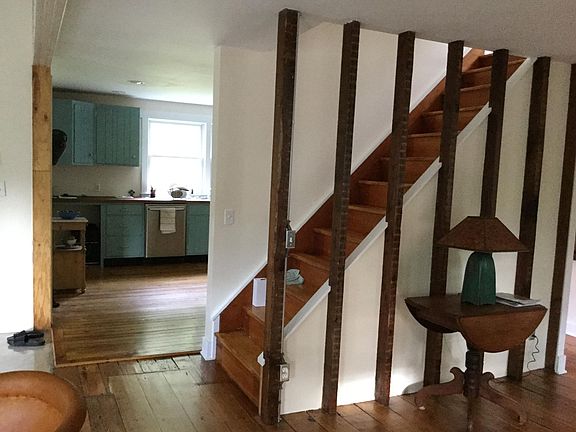 Exposed antique wood, original floors. View from Dining room to kitchen