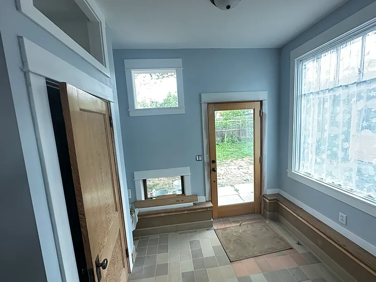 Mudroom area inside the back door. Door on left goes to unfinished large basement with washer & dryer, storage space. Furnace and hot water heater easily accessible.