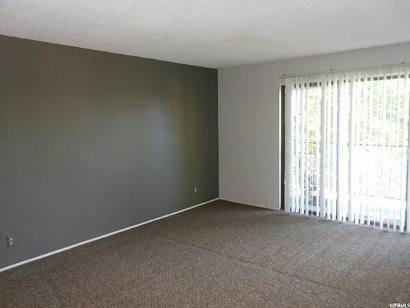 Living room with triple wide sliding glass door