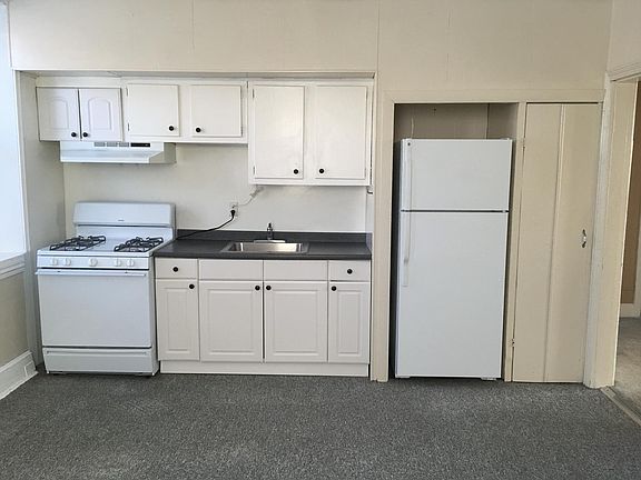 Large eat-in kitchen with newer stove and refrigerator