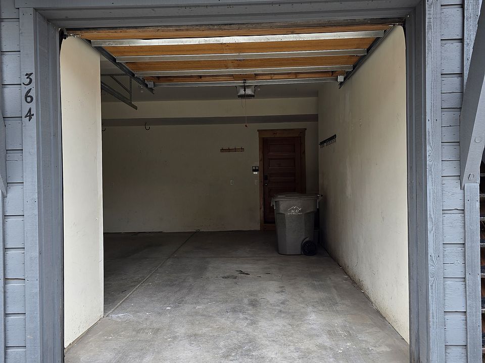 Garage space, very narrow, likely would not be wide enough for a truck.