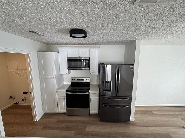 Additional kitchen view featuring stainless steel appliances and storage.