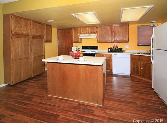 Beautiful kitchen with hardwood floors, large cabinets and an is