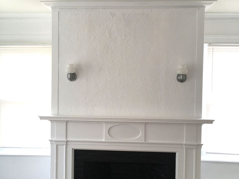 Decorative fireplace in the larger primary bedroom
