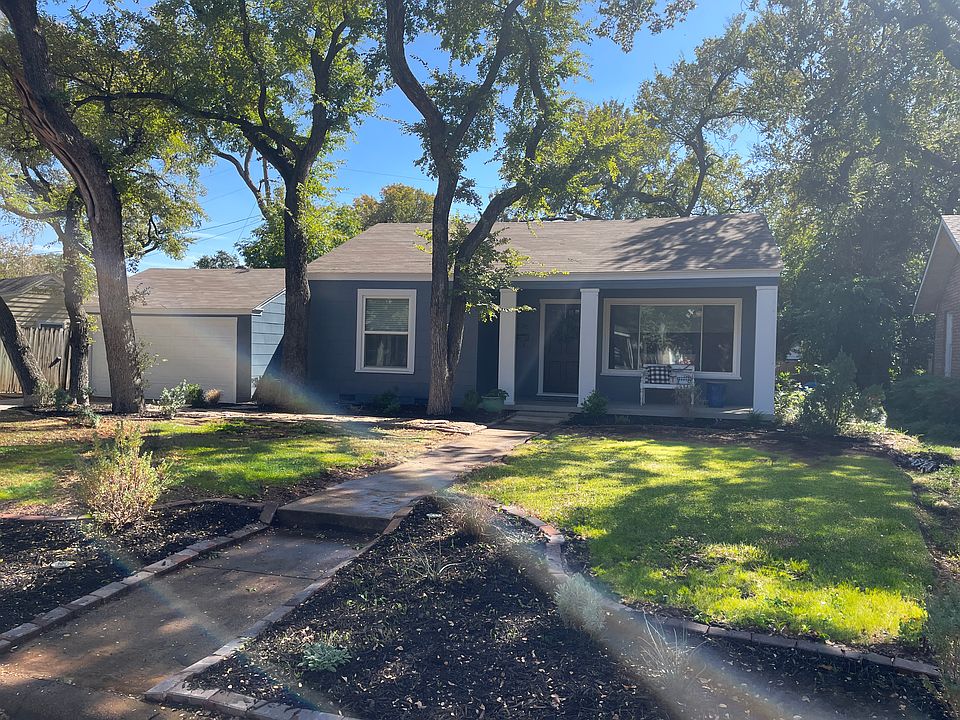 Front of home - large garage, lots of trees, and a nice sized front porch to greet visitors.