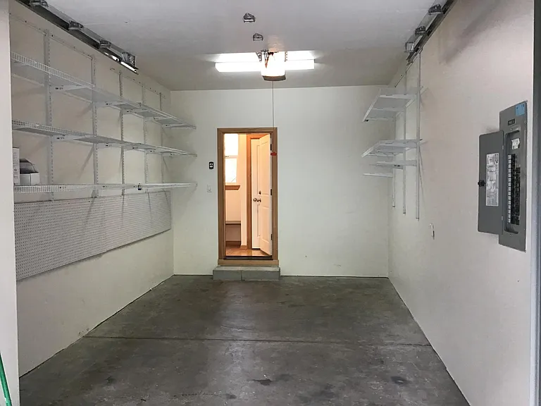 Garage with lots of shelves and peg board