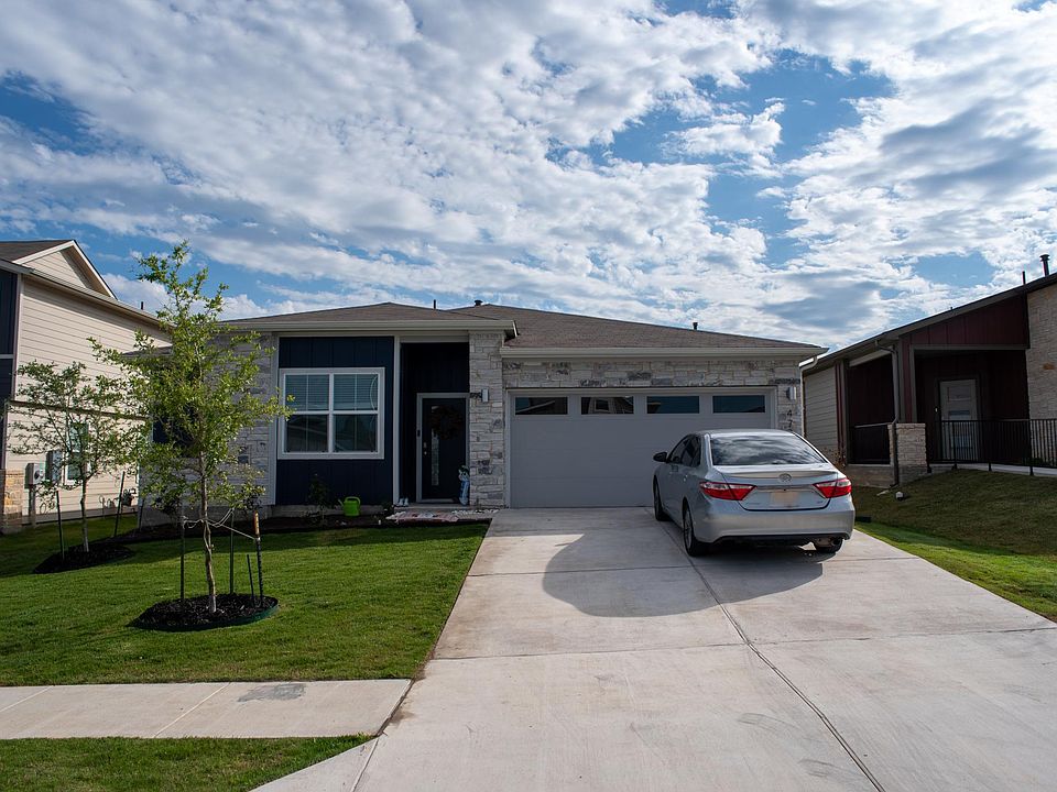 House front with well taken-care-of lawn.