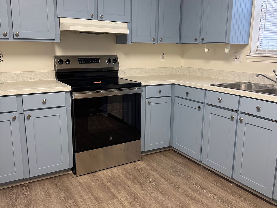Eat-in kitchen features: new flooring, countertops, range, dishwasher, and refrigerator.