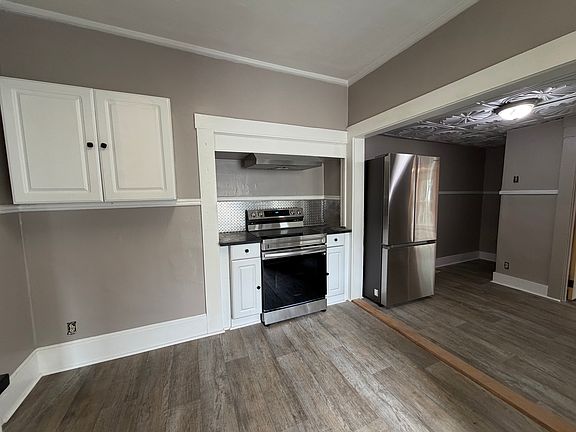 Additional view of the large kitchen with a new Samsung stove and fridge