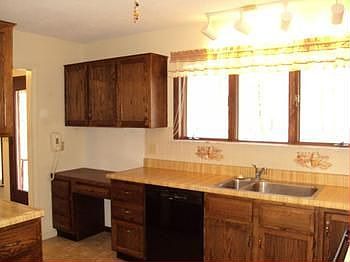 There is a desk for your computer in the kitchen.