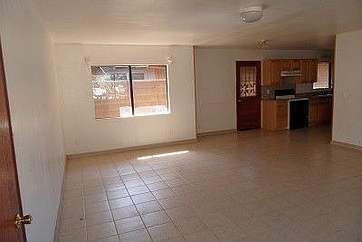 Adjacent kitchen is dining area with door to left side yard