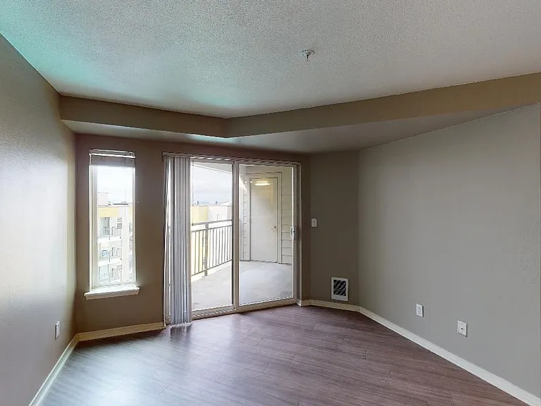 Apartment living room with wood-style flooring.