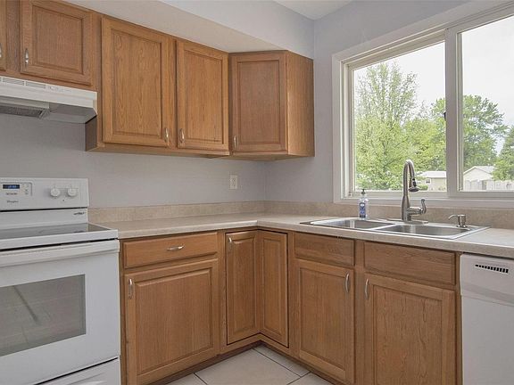 Kitchen -- new cabinets & pulls; smooth top electric stove; new tile; newer faucet.