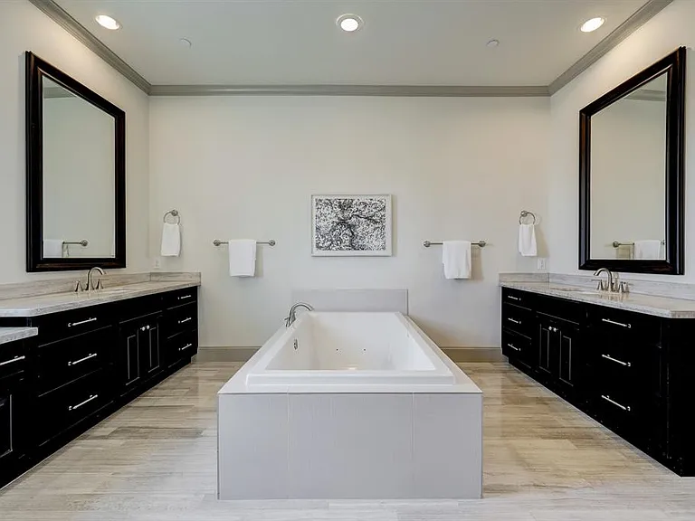 The spa like primary bath features two oversized vanities, dual sinks, walk-in shower, separate tub, and a private water closet.
