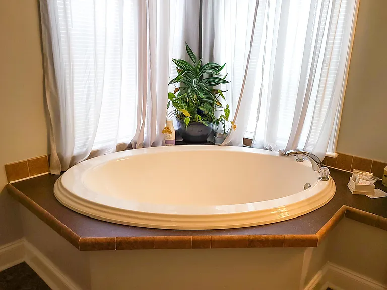 Master suite bath spa tub, complete with bath salts and bubbles.
A baby tub is in Bedroom 3's closet, which fits perfectly in this tub. Or, have a moment for yourself while relaxing in the tub!