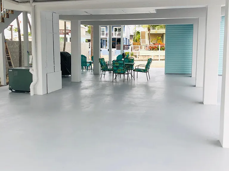 Concrete open ground level with ample room for entertaining and parking.