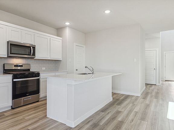 Kitchen in the Willow home plan by Trophy Signature Homes - REPRESENTATIVE PHOTO
