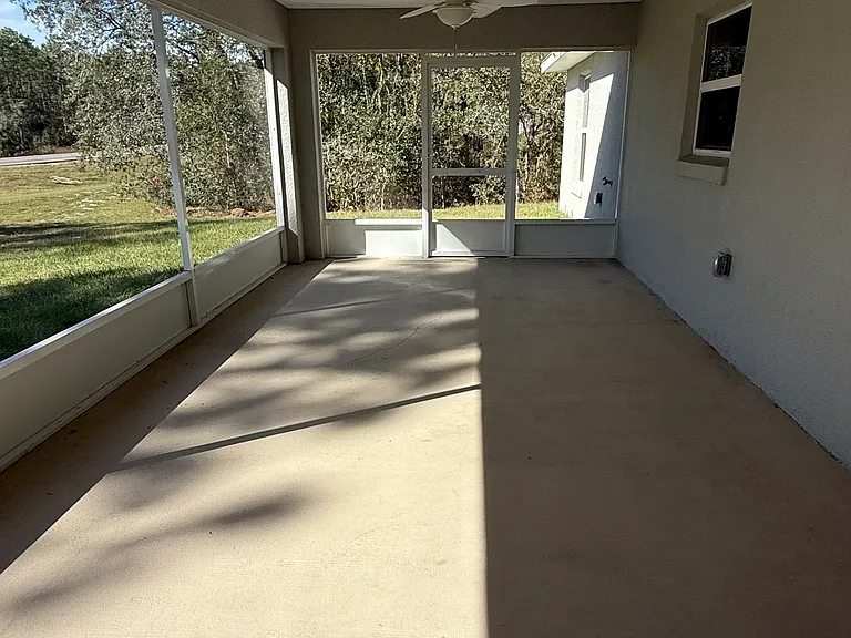 Screened in lanai with outdoor fans with lights.