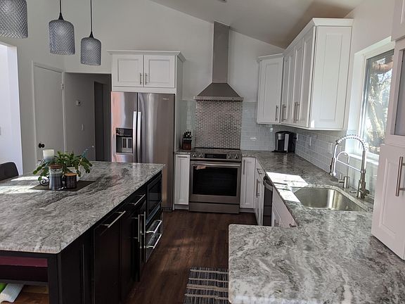 Upgraded kitchen with stainless steel appliances and granite countertops