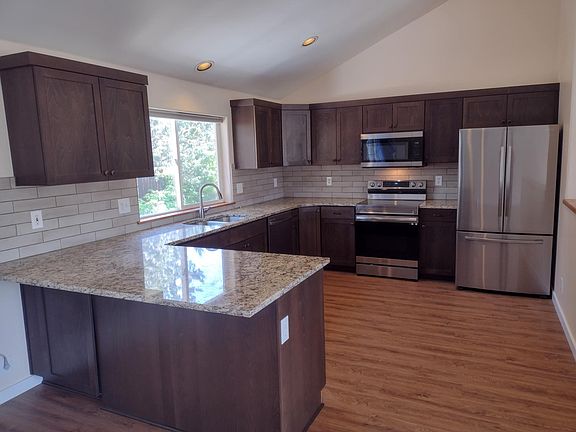 Remodeled kitchen with stainless steel appliances and granite countertops.