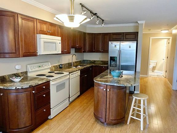 Kitchen and entry hall with guest bathroom.