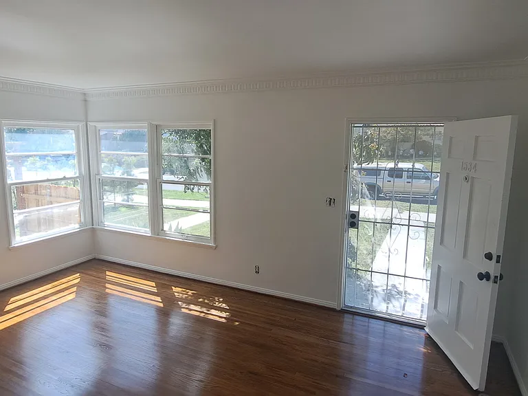 Living room with faux fire place heater, New hardwood floors oak, will have window ac unit with wifi access. Size is 12'x18' sq feet.