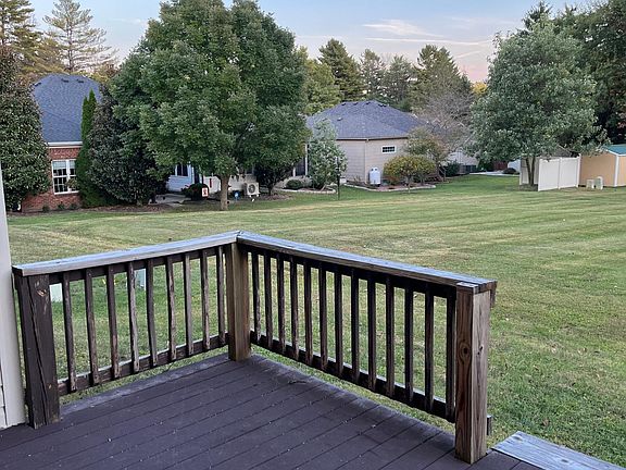 Deck looks over a large grassy area. Mowing responsibly ends approximately 10 feet off the back deck.