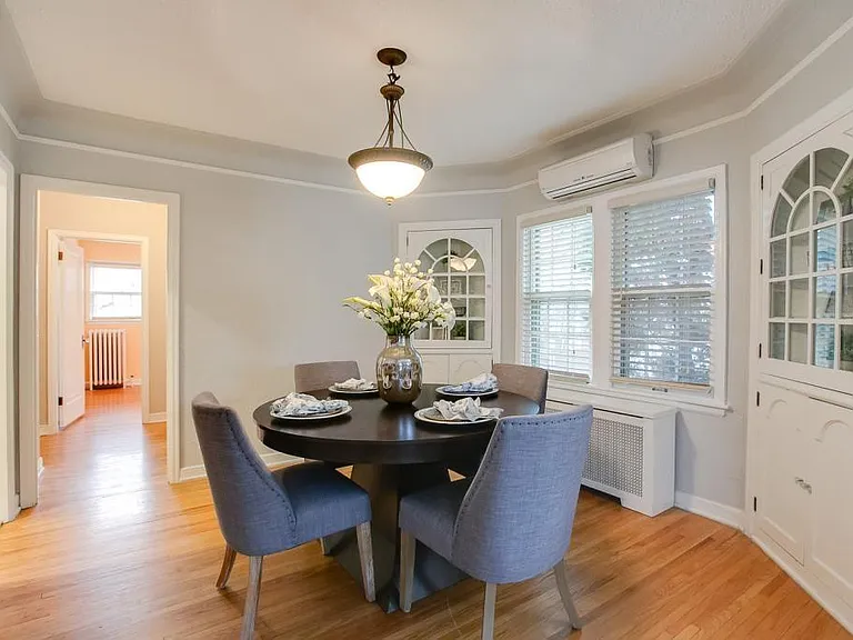 Dining room from living room. Note Split A/C,which includes remote also provides additional heat option in colder months. Looks east toward "linen hall," bath, smaller bedroom/office at back of house.