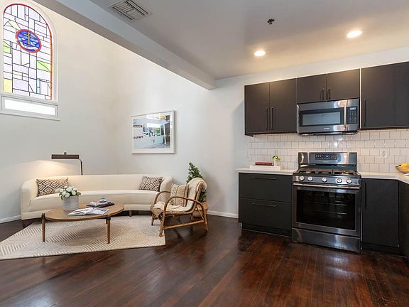 Main living area with vaulted ceilings and original stain glass windows