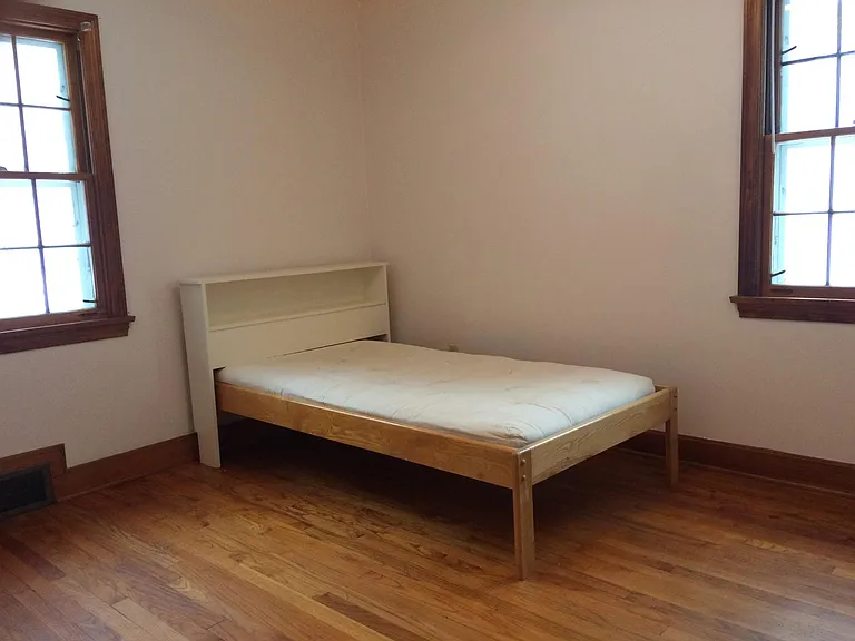 bedroom at south end of house facing side and backyard with small single bed (9.5' x 11')