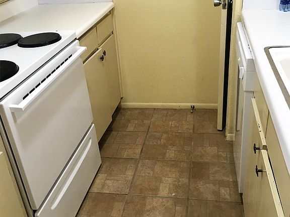 Kitchen complete with a fridge, dishwasher and stove.