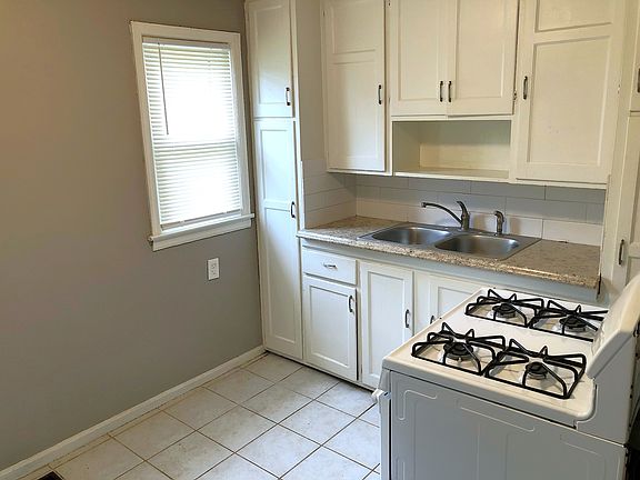 Kitchen, tile flooring, gas oven/range, fridge