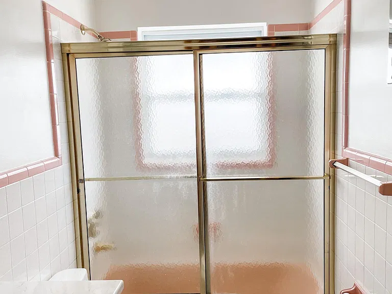 Large frosted window in bathroom allows light in but keeps privacy.
