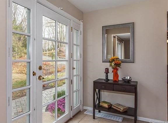 front foyer with view of new stone walkway and beautiful front door