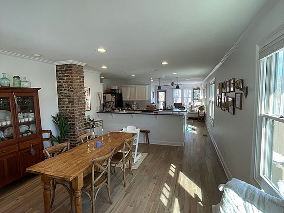 Open floor concept with plenty of sunlight and exposed brick