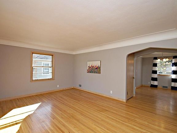Open and inviting floor plan. Fantastic living room with oh so coveted coved ceilings and original hardwood floors.