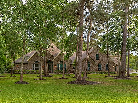 Great curb appeal with towering trees and mature landscaping in beautiful estate neighborhood of Sendera Lake Estates with direct access to riding neighborhood riding trail.