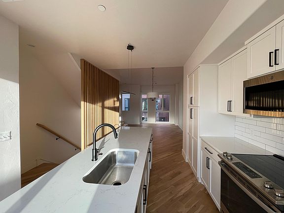 Beautiful kitchen with GE appliances, half bath, and living room on 2nd floor, separated from 3rd floor bedrooms.