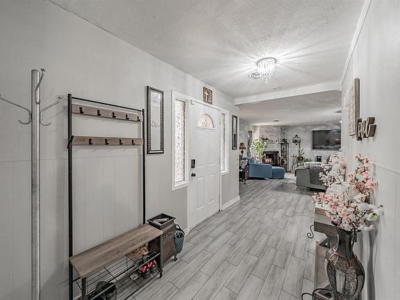 Entrance foyer featuring tiled flooring, a textured ceiling, and a fireplace