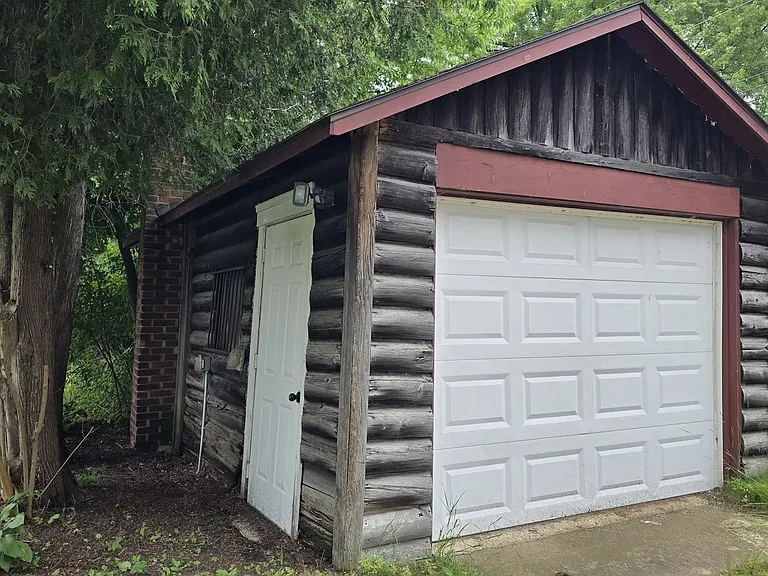 Cabin garage has electricity and garage door opener